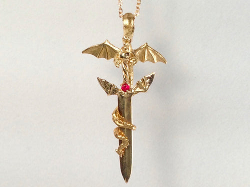 winged dragon holding a sword, winged dragon holding a sword necklace, winged dragon holding a gemstone sword, golden winged dragon holding a sword,